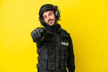 Fototapeta premium SWAT caucasian man isolated on yellow background points finger at you with a confident expression