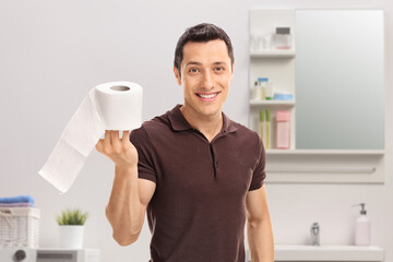 Guy holding a roll of toilet paper