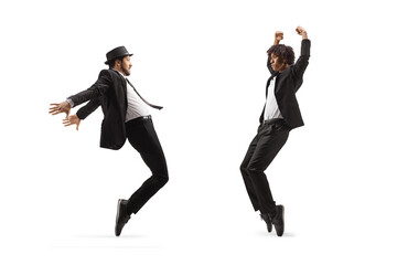 Full length shot of a male dancers in black suits dancing
