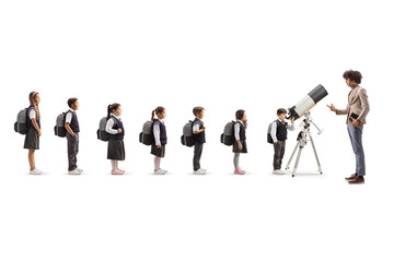 Man talking to schoolchildren waiting in line to use a telescope