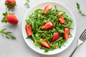 Fresh Strawberry Arugula Salad With Pine Nuts Served on a Bright Day
