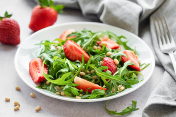 Fresh Strawberry Arugula Salad With Pine Nuts Served on a Bright Day