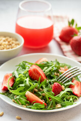 Fresh Strawberry Arugula Salad With Pine Nuts Served on a Bright Day