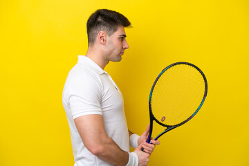 Young caucasian man isolated on white background playing tennis