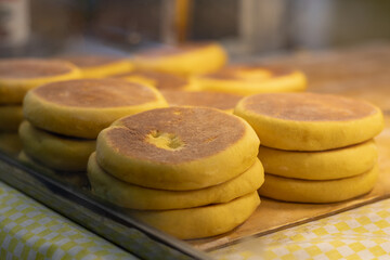Horizontal photograph of a small Mexican snack retail business selling gorditas de nata in the local market for tourists on vacation in Mexico