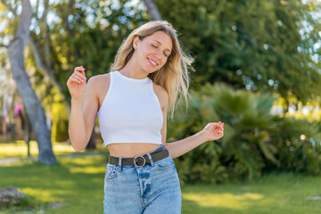 Young blonde woman at outdoors . Portrait