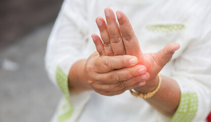 close up senior woman massage on fingers to relief pain from hard working for treatment about gout and rheumatoid symptoms and chronic illness health care concept - obrazy, fototapety, plakaty