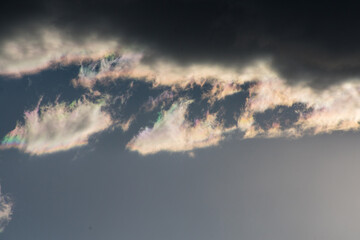 Naklejka na ściany i meble iridescent cloud in the blue sky