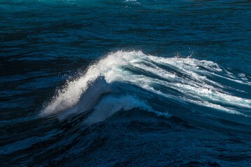 Closeup shot of foamy sea waves splashing in the sea