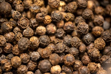 Closeup shot of black peppercorns background