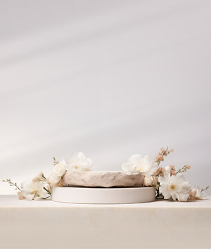 Stone podium for product display with white flowers. Gray showcase mockup