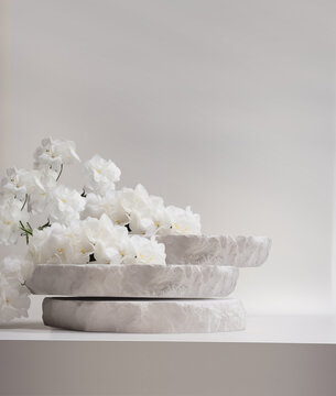 Stone podium for product display with white flowers. Gray showcase mockup