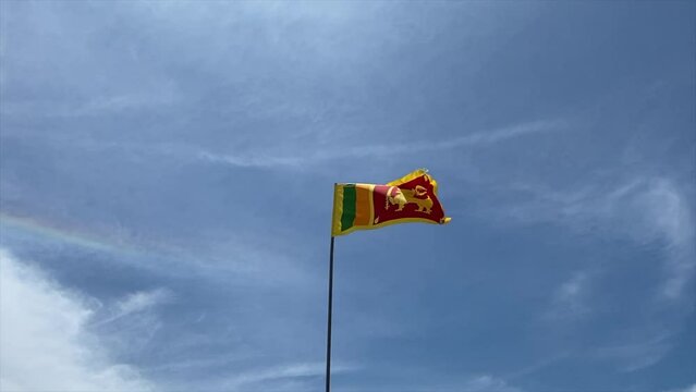 Low angle shot of the Sri Lanka flag waving in a blue sky