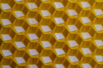 Background texture and pattern of section voshchina of wax honeycomb from a bee hive for filled with honey. Voshchina an artificial basis for the construction of honeycombs, sheet of wax of cells - 783627774
