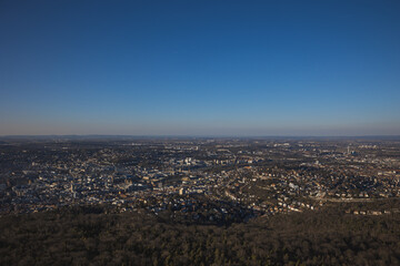 Scenic cityscape of Stuttgart with dense buildings and trees under the blue clear sky