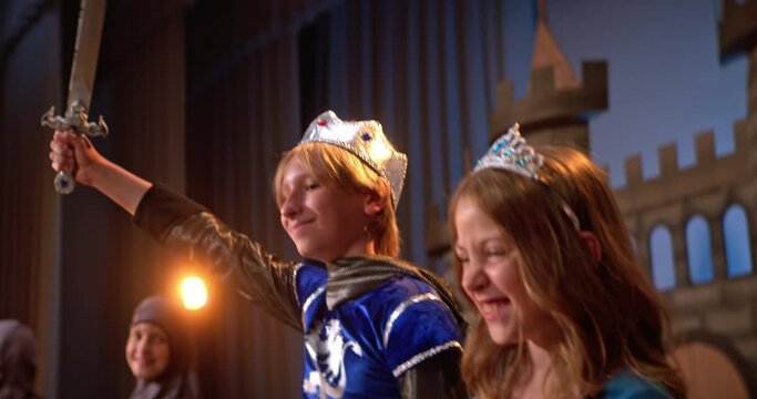 School play depicting medieval times with children in costumes on stage