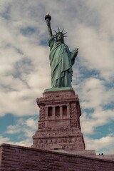 Fototapeta premium Statue of Liberty in New York against a backdrop of dark clouds