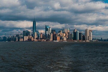 Fototapeta premium View of Lady Liberty from Liberty Island with the background of a cloudy sky