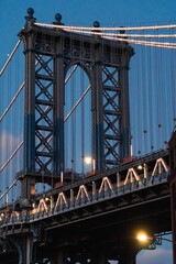 Vertical low angle shot of the Manhattan bridge in New York, during sunset hours