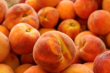 Closeup of stack of plump juicy peached at a farmer's market