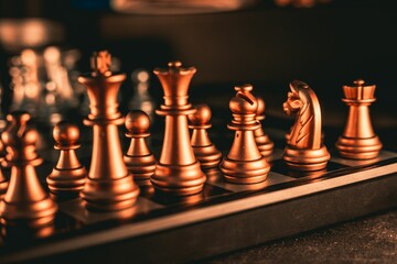 Close-up shot of golden chess pieces on a chessboard