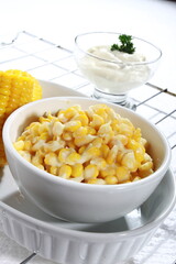 Vertical shot of a white bowl with corn