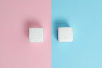 Two Objects Arranged Facing Inward Outward On a Separated Coloured Background