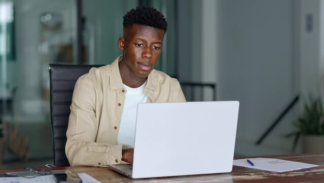 Busy professional African young business man company employee, Black male worker software developer businessman typing on computer technology using laptop thinking working at office desk.