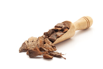 Front view of a wooden scoop filled with Organic Banyan or Banian (Ficus benghalensis) bark. Isolated on a white background.