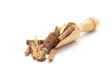 Front view of a wooden scoop filled with Organic Liquorice or Mulethi (Glycyrrhiza glabra) roots. Isolated on a white background.