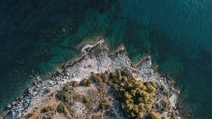 Aerial top view of a green island against the sea