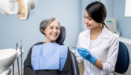 Fototapeta premium Happy elderly woman talking to her orthodontist during appointment at dentist's office.