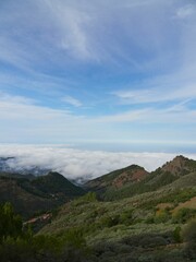 Fototapeta na wymiar Mountain summits with sea of clouds in the background on a sunny day in Gran Canaria, Spain