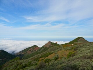Fototapeta na wymiar Landscape of the green mountain peaks with sea of clouds in the background in Gran Canaria, Spain