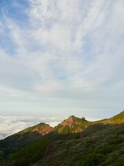 Scenic view of the green mountain summits over the clouds in Gran Canaria, Canary Islands, Spain