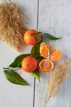 Top view of fresh, juicy oranges on a white painted wooden surface