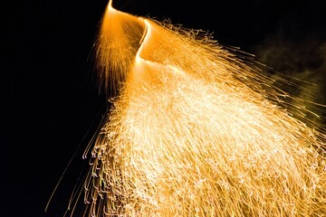 Beautiful shot of a firecracker in motion isolated on a dark background