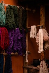 Vertical shot of different colorful wool yarns on display in Peru