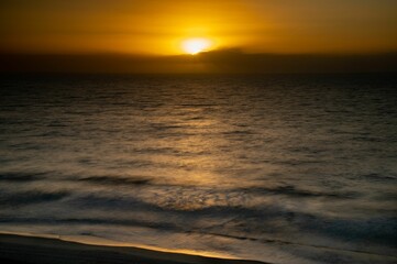 Fototapeta premium Beautiful shot of a bright sunset sky over the blue sea