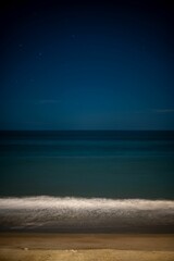 Vertical shot of a dark evening sky over a seashore