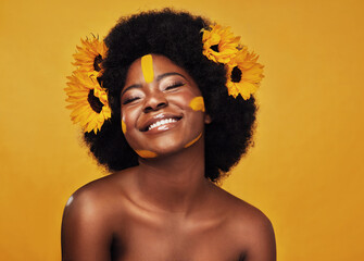 Black woman, sunflower and paint in studio with makeup for beauty with creative, confidence and...