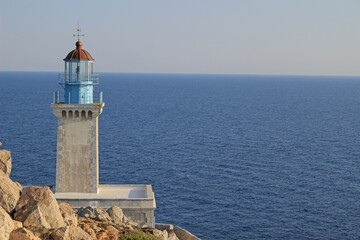 Fototapeta na wymiar Cape Tainaro lighthouse in Mani Greece with the blue sea and the horizon in the background
