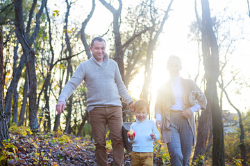 Happy family together on autumn picnic in the evening