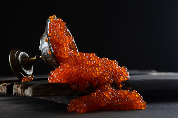 Red caviar. Caviar spilled out of the vase. Lots of caviar. Salmon roe. A delicacy. Seafood. A...