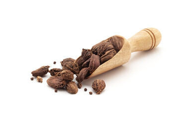 Front view of a wooden scoop filled with Organic Black cardamom (Amomum subulatum). Isolated on a white background.