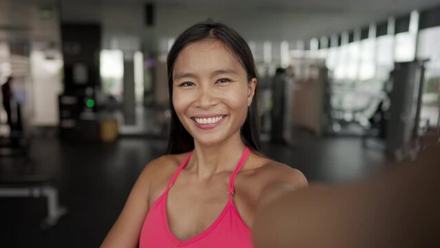 Self-portrait or selfie at gym in sportswear post workout, motivation and achievement