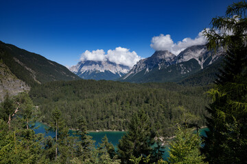 View from Austrian Fern Pass to deep blue lakes amidst mountains, picturesque landscape, alpine scenery.