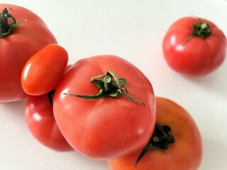 Many tomatoes on creamy background.