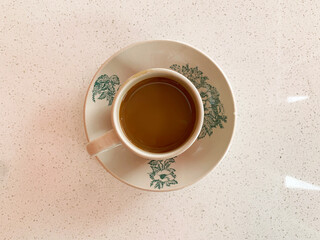 hot drink milk tea leaf bag, milo , kopi coffee mocha with milk in traditional cup and tea spoon and small plate on wood table color vegan healthy restaurant beverage cafe halal food menu