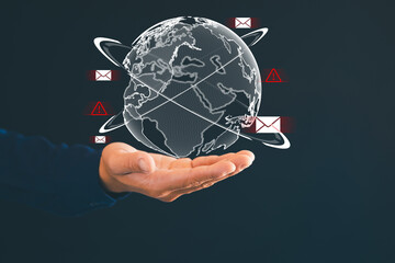 The man's finger points to the earth icon, displays the dangerous email icon, sends spam through...